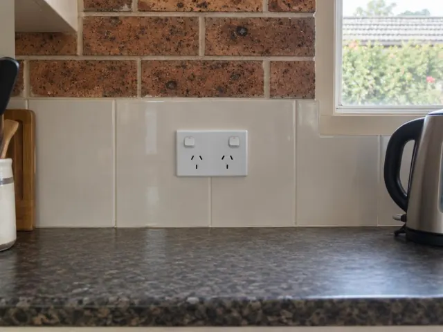Double power point on a tiled kitchen splashback above a benchtop in Davidson